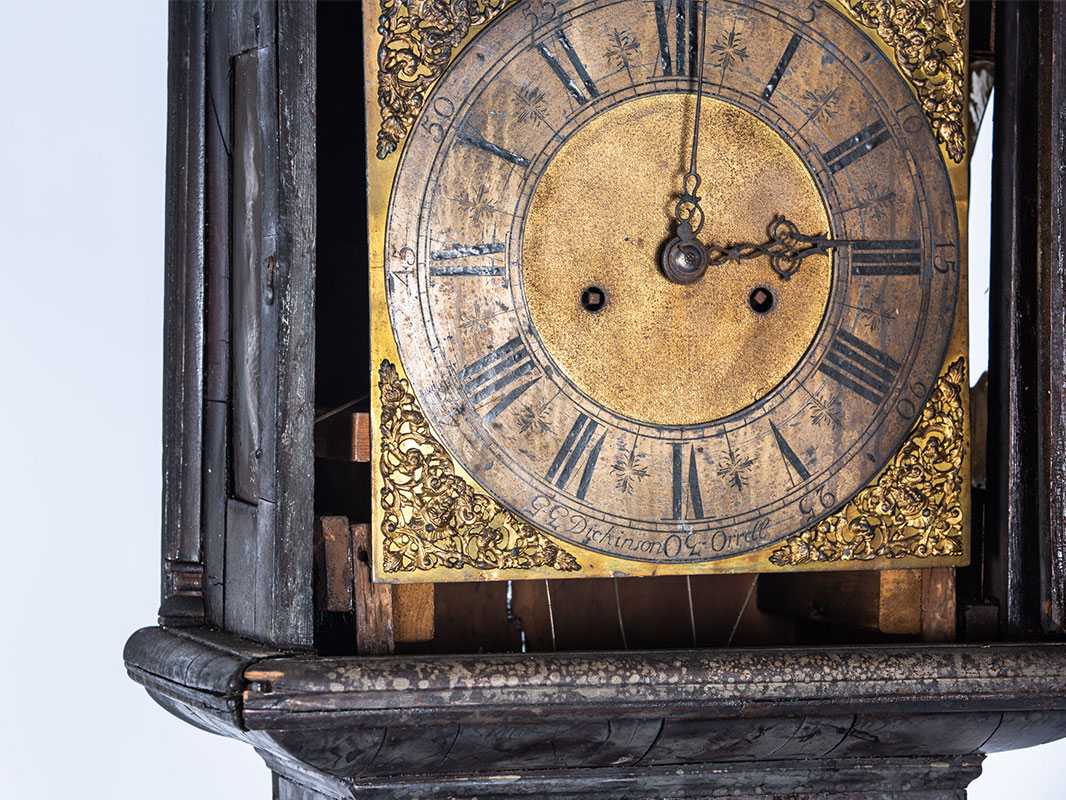 a longcase clock before furniture restoration treatment in the Plowden & Smith furniture restoration studio